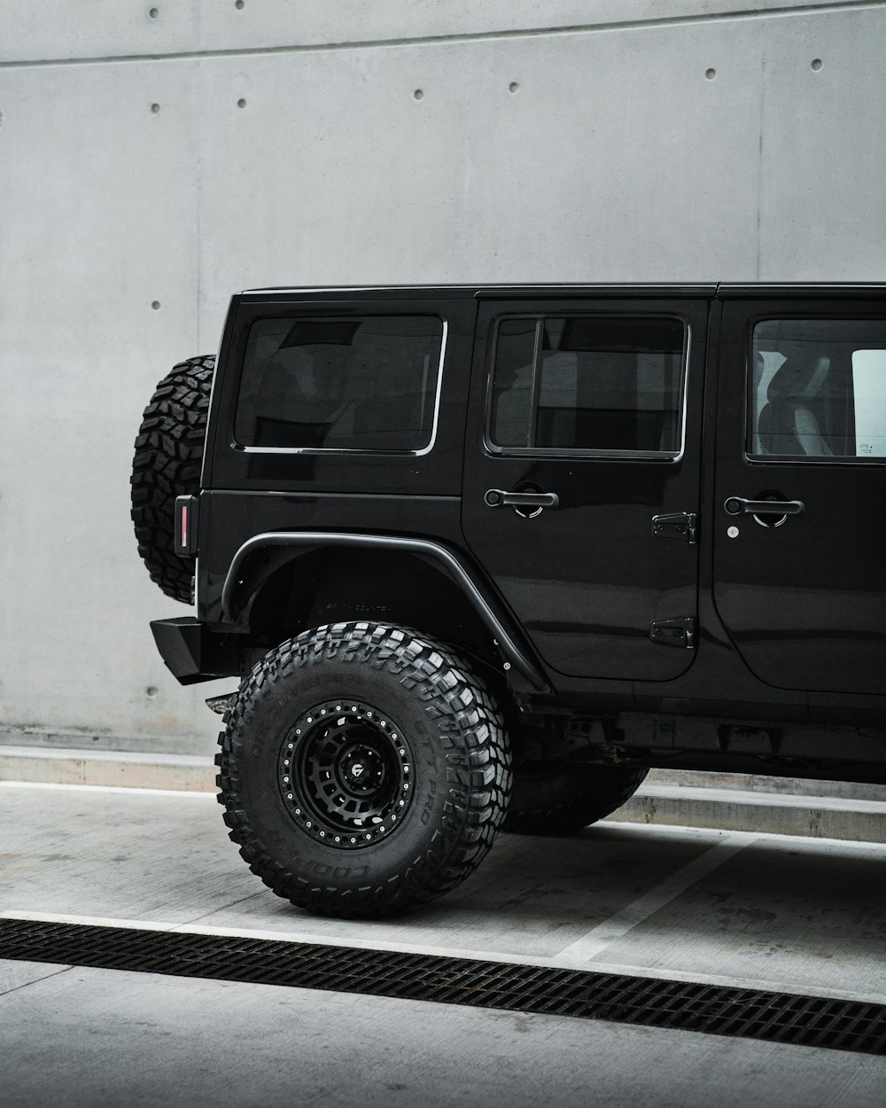 a black jeep parked in front of a building