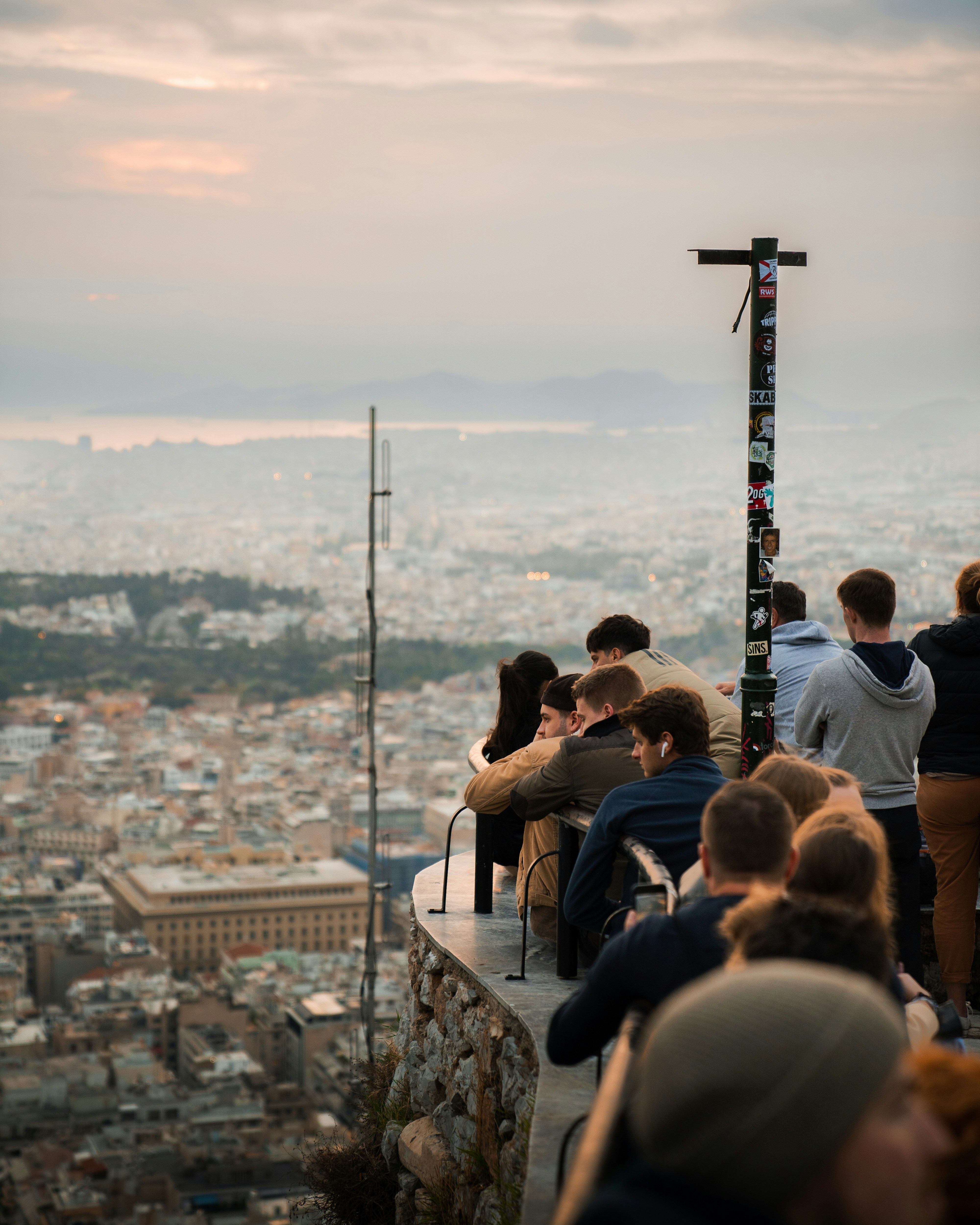 a group of people sitting on top of a tall building