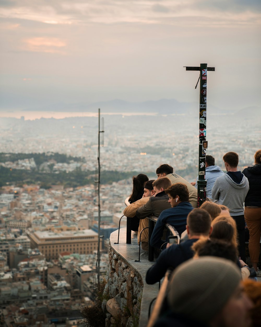 a group of people sitting on top of a tall building