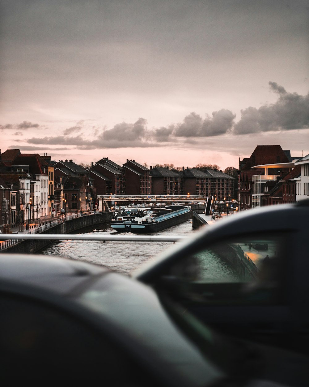 a view of a river with cars parked on the side of it