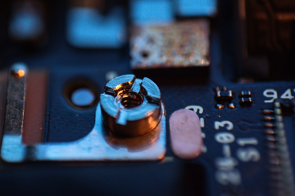 a close up of a circuit board with a screw