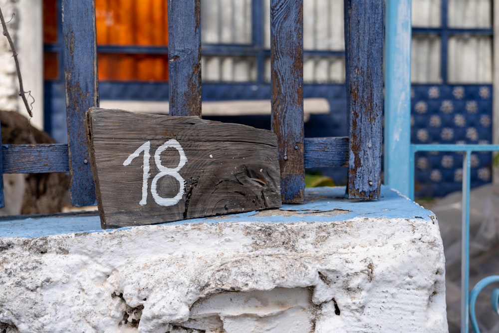 a wooden sign sitting on the side of a building