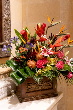 a wooden box filled with lots of colorful flowers