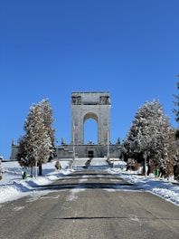 a large monument in the middle of a snowy park