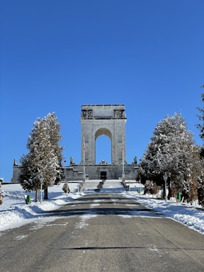 a large monument in the middle of a snowy park