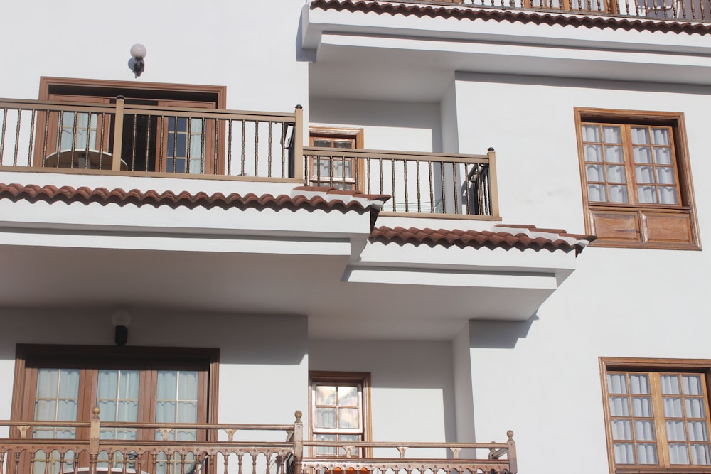 a white building with balconies and a balcony