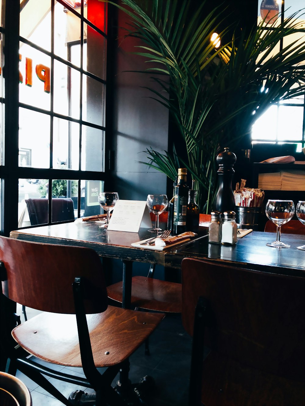 a restaurant table with wine glasses on it