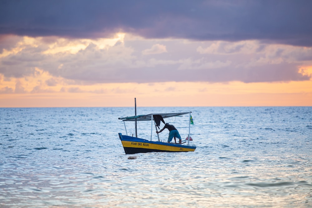 a man standing on a boat in the middle of the ocean