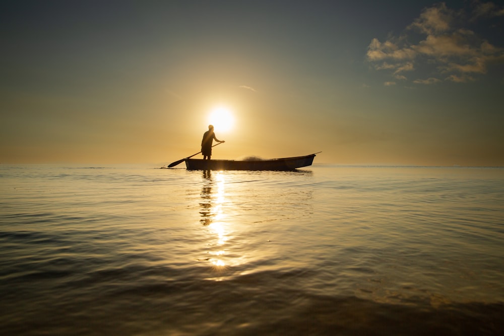 a person is paddling a boat in the water