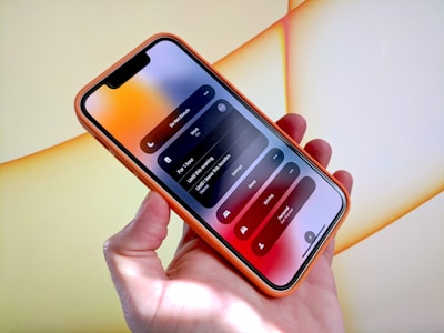 a person holding a cell phone in their hand