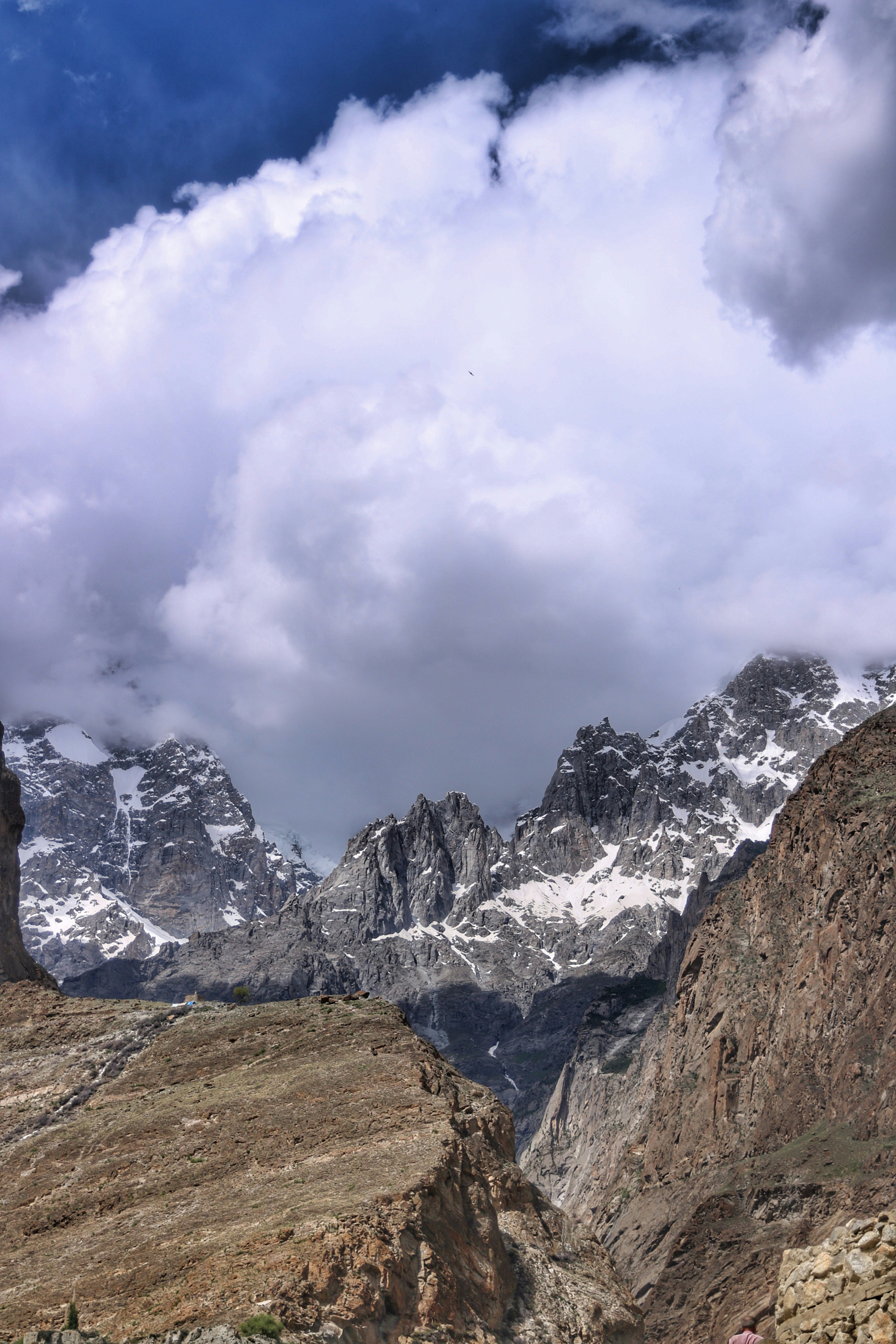 a mountain range with snow capped mountains in the background