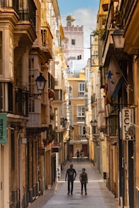 a couple of people that are walking down a street