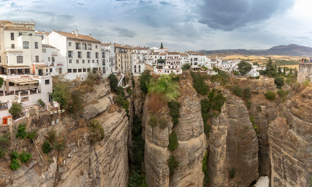 a city on a cliff surrounded by tall buildings