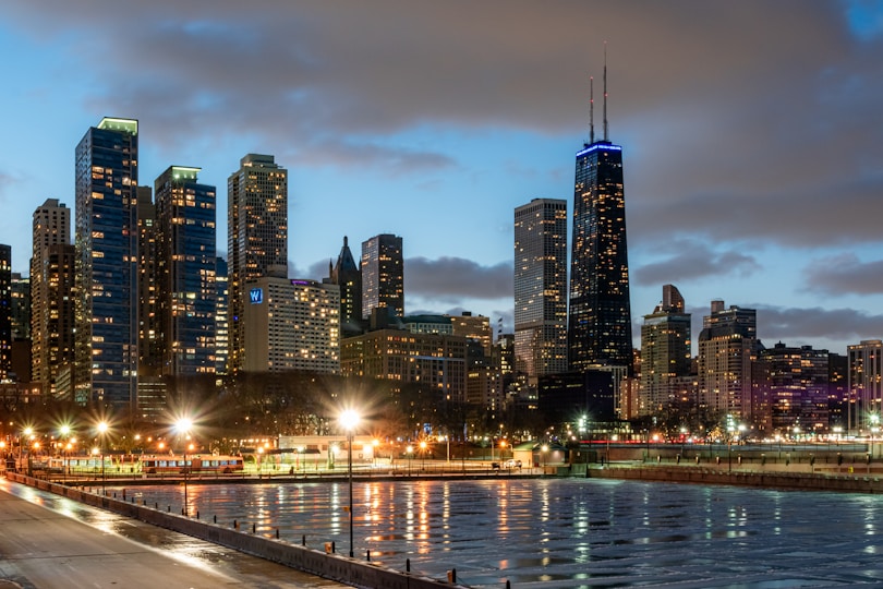 a city skyline at night with lights reflecting in the water