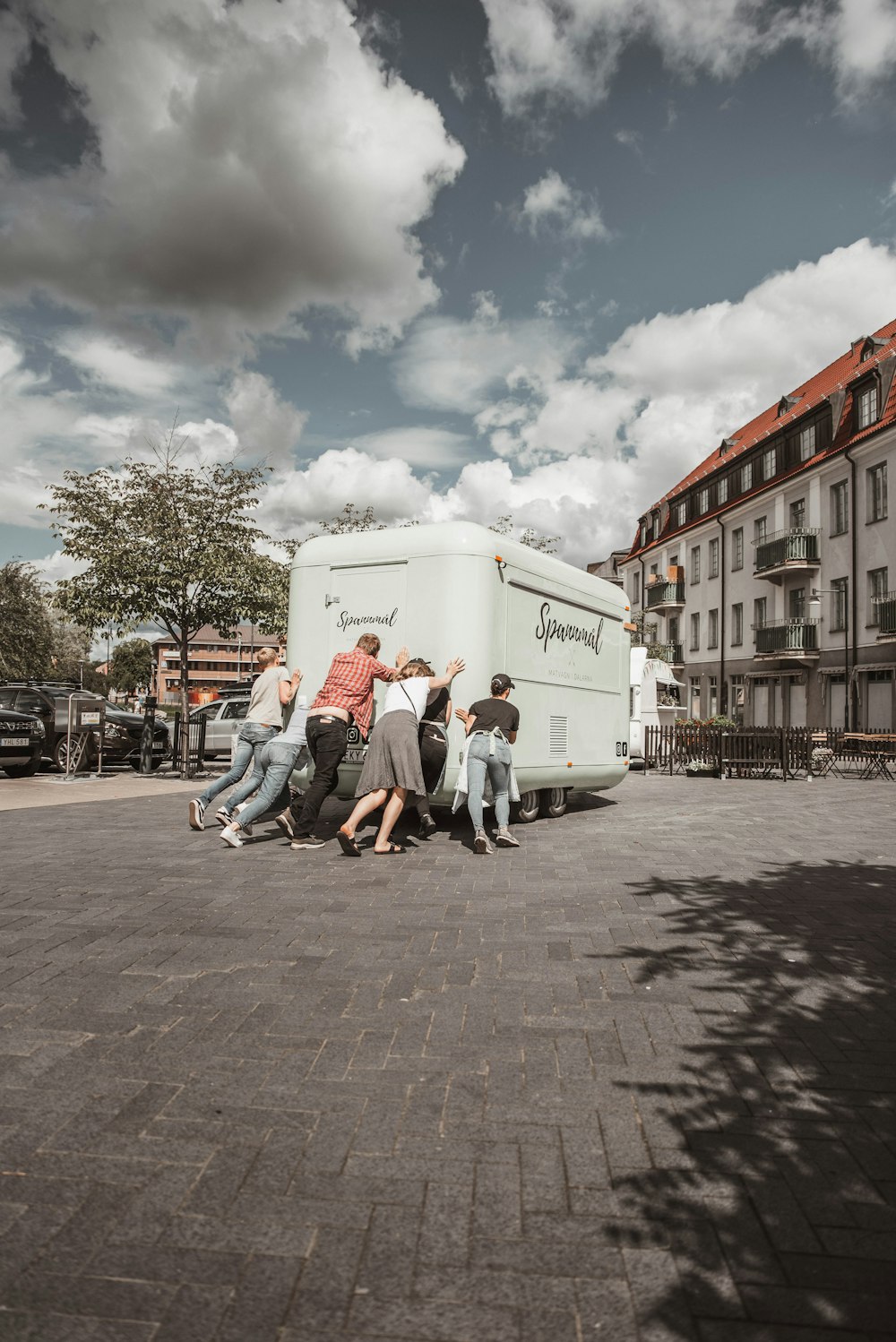 a group of people standing around a food truck