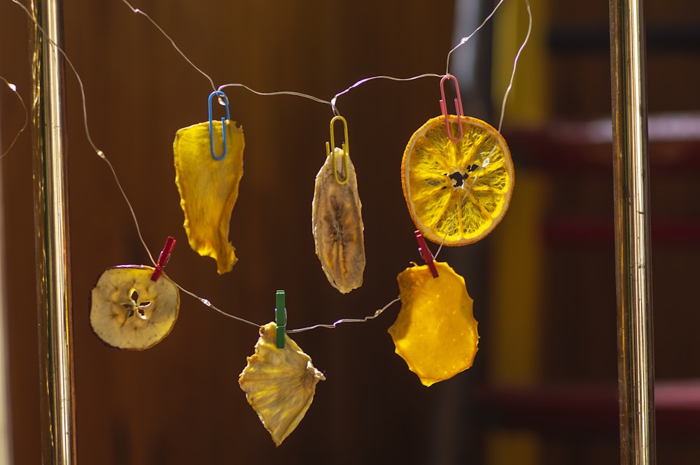 a group of dried fruit hanging from a line