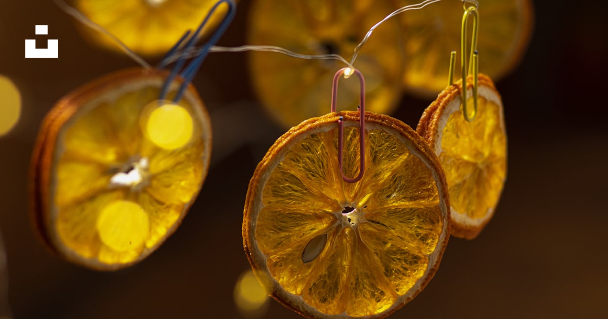 A group of orange slices hanging from a string photo – Free Care Image ...