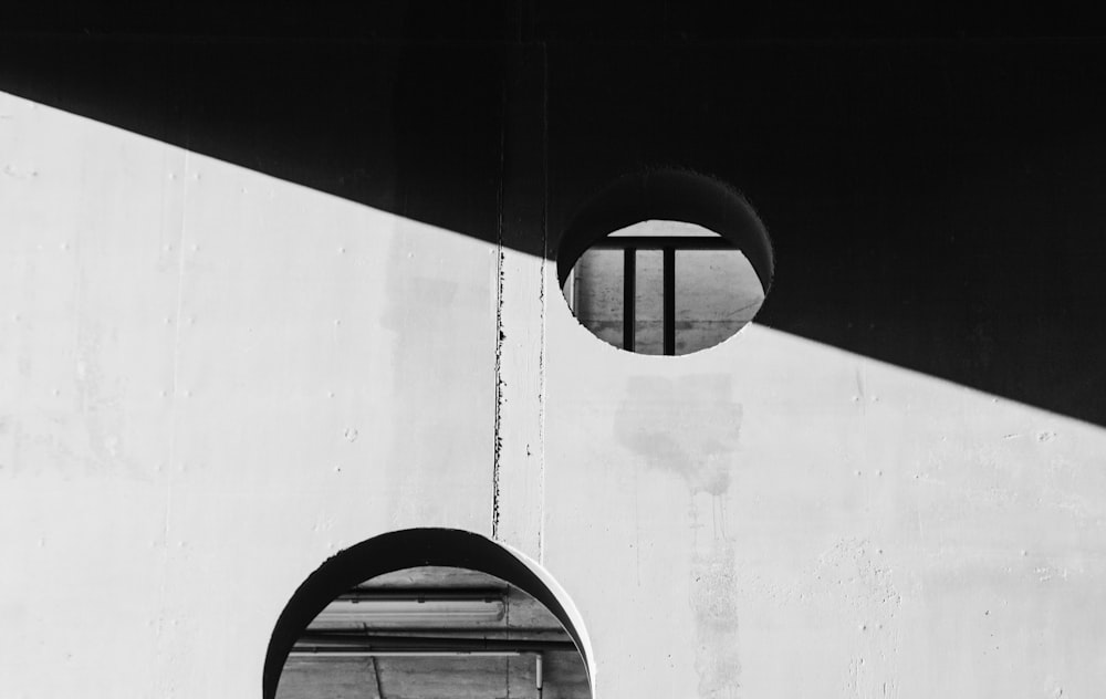 a black and white photo of two circular windows