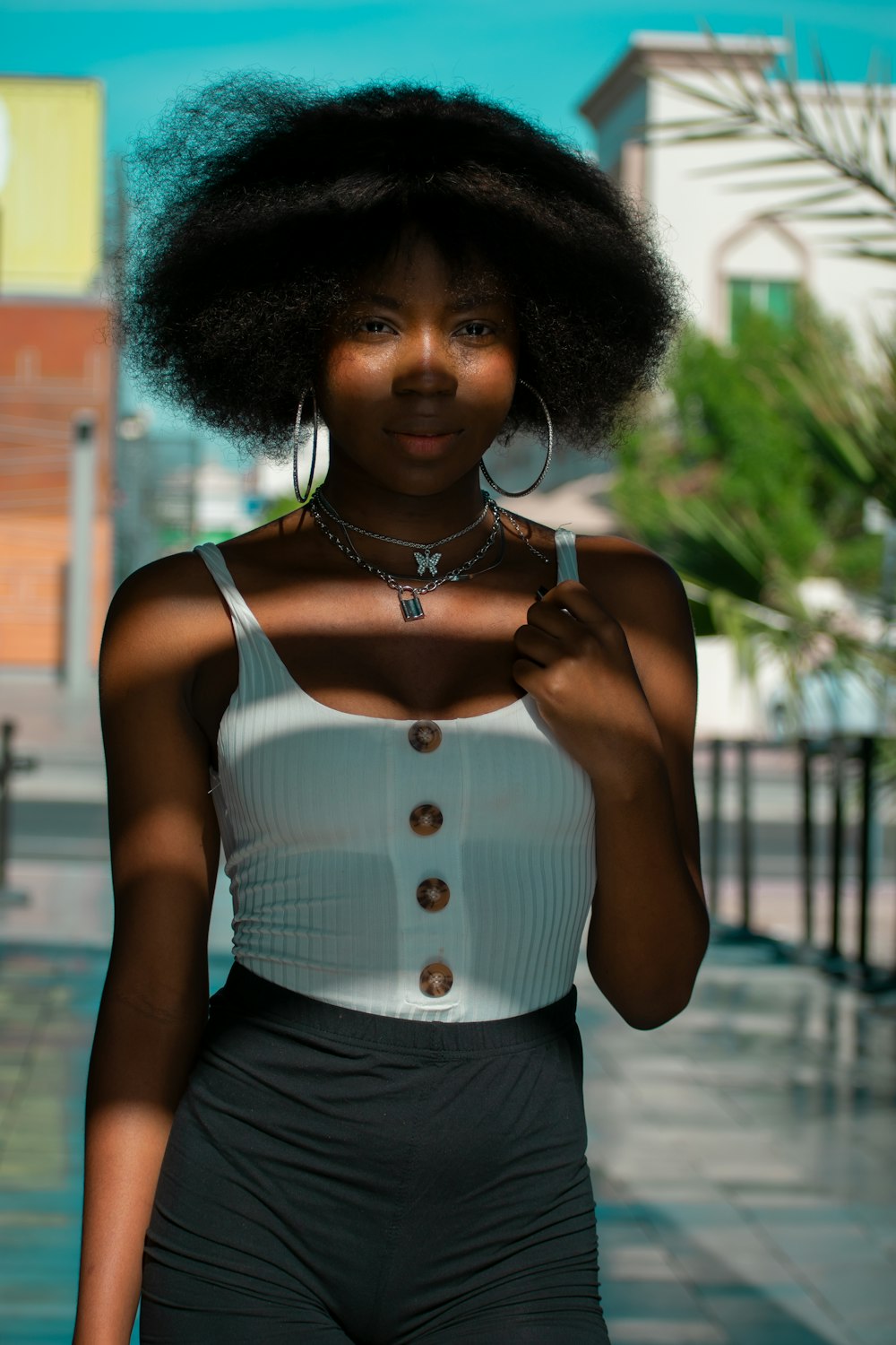 a woman with an afro is walking down the street