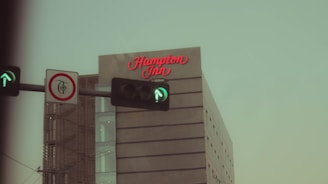 Directional signage showing the north-to-south route with stops at Hampton Inn, Holiday Inn, and La Quinta.