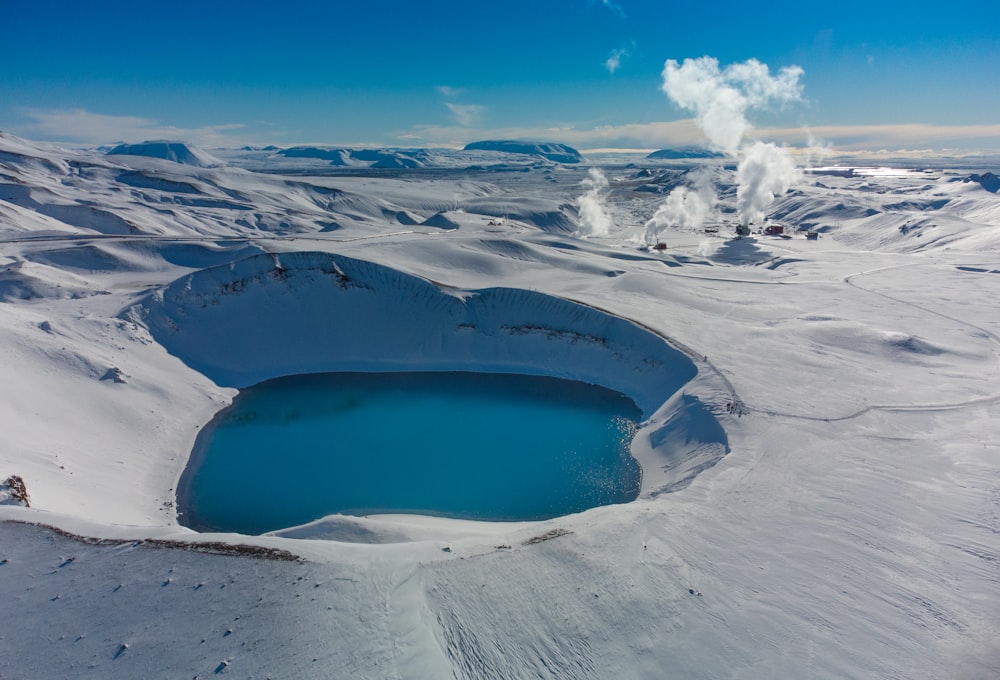 a snow covered landscape with a large crater in the middle