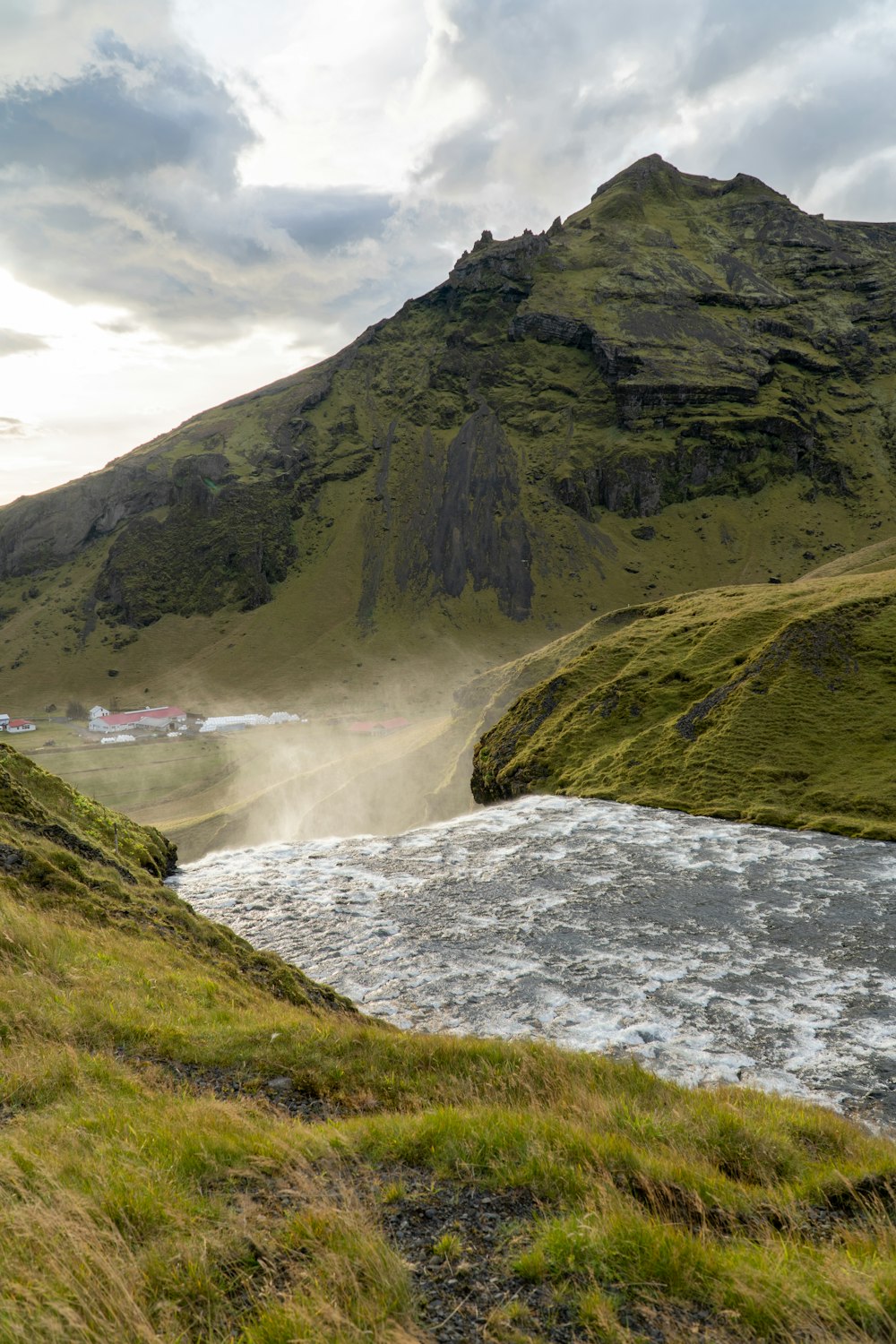 a river running through a lush green valley