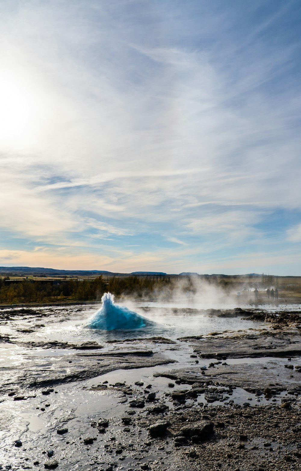 a large body of water with steam coming out of it