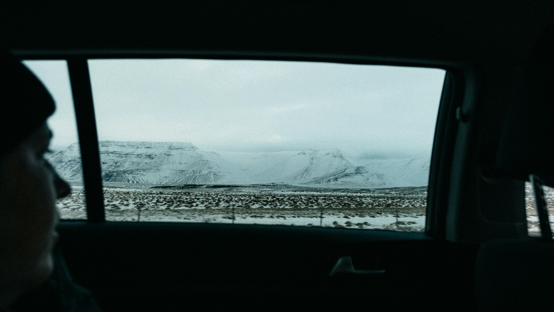 a person in a car looking out the window