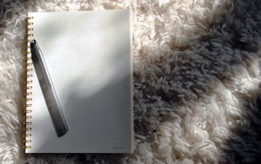a notebook with a pen on top of it