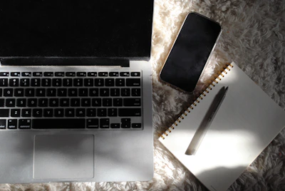 an open laptop computer sitting on top of a white rug