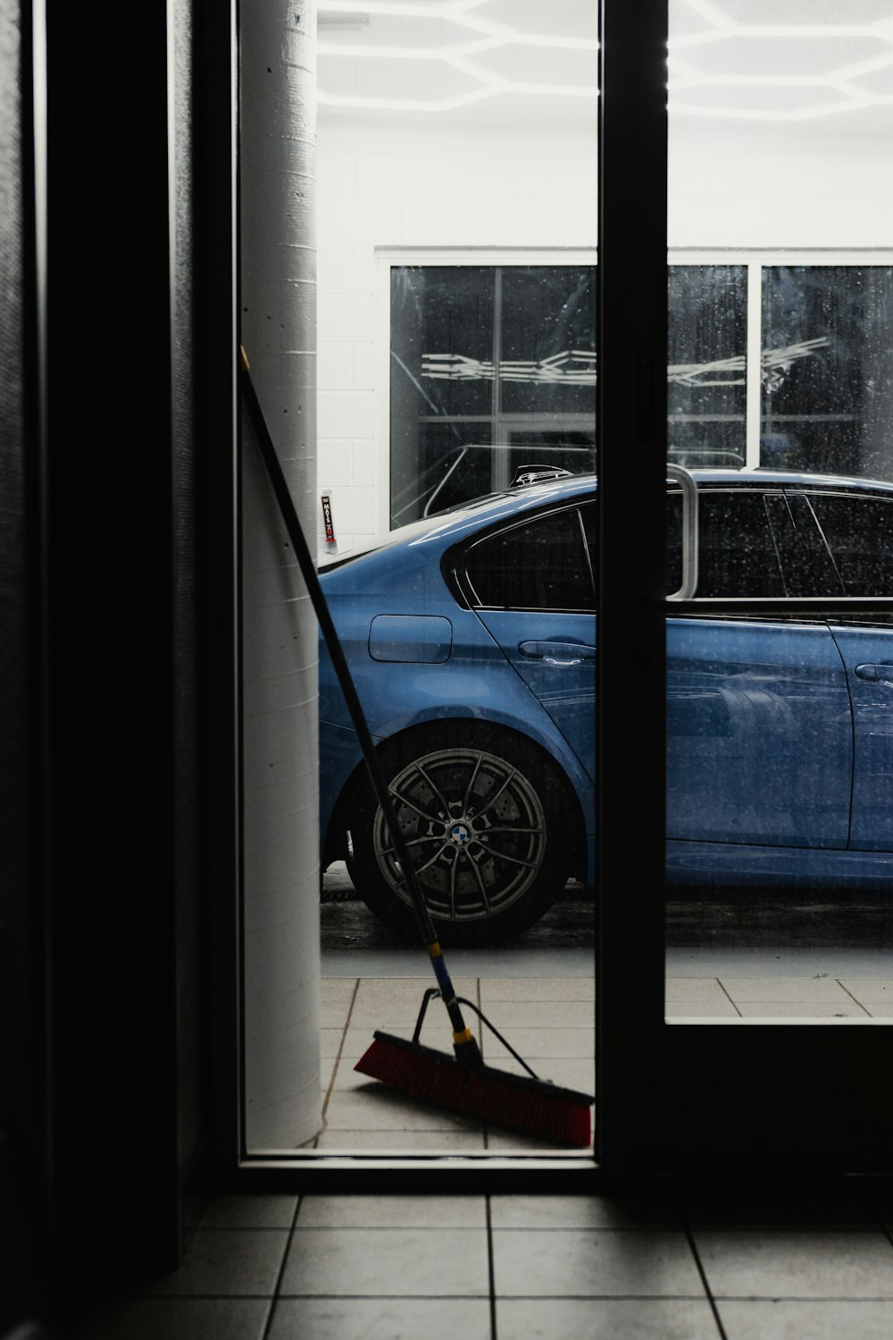 a blue car is parked in a garage