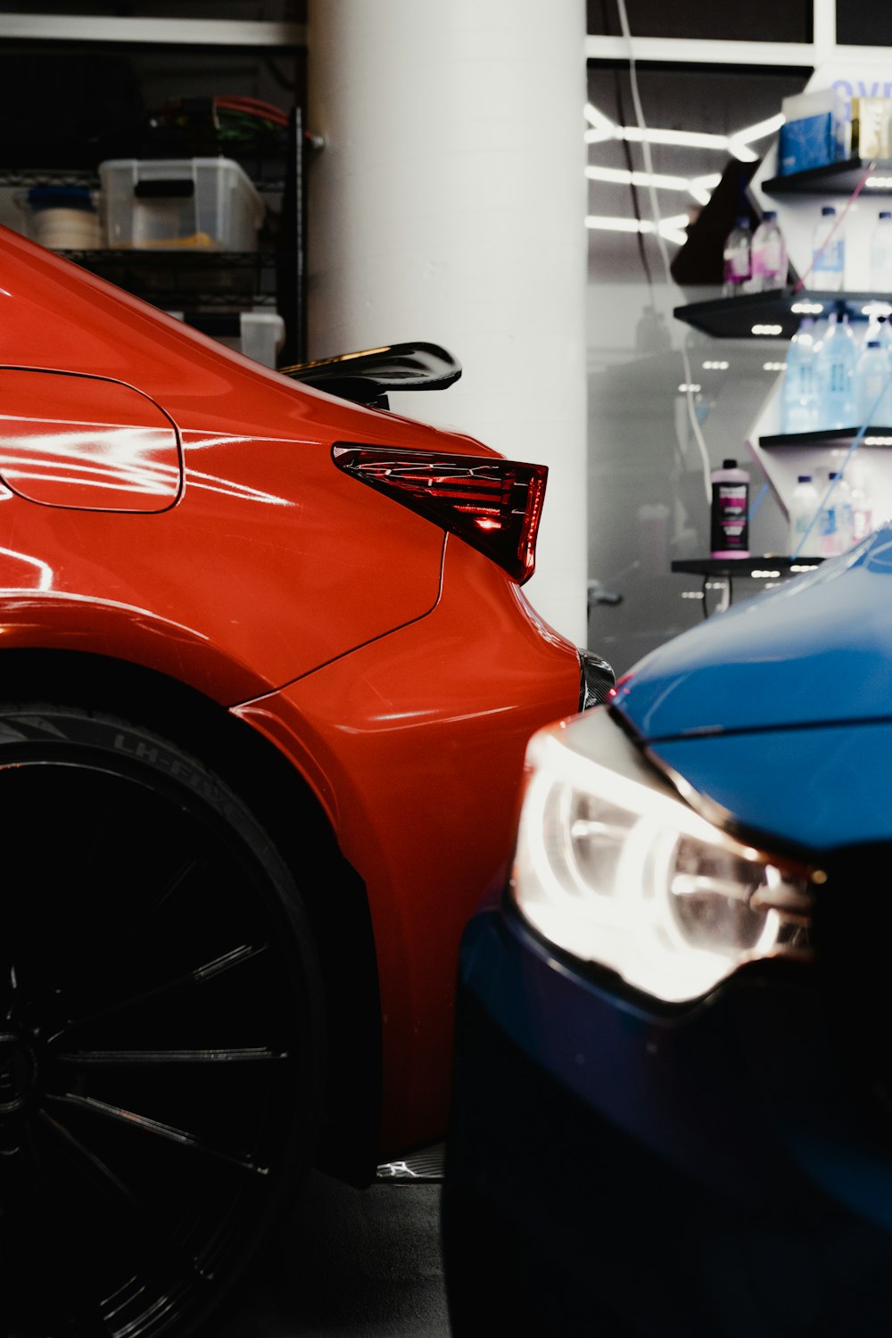 a red car parked next to a blue car