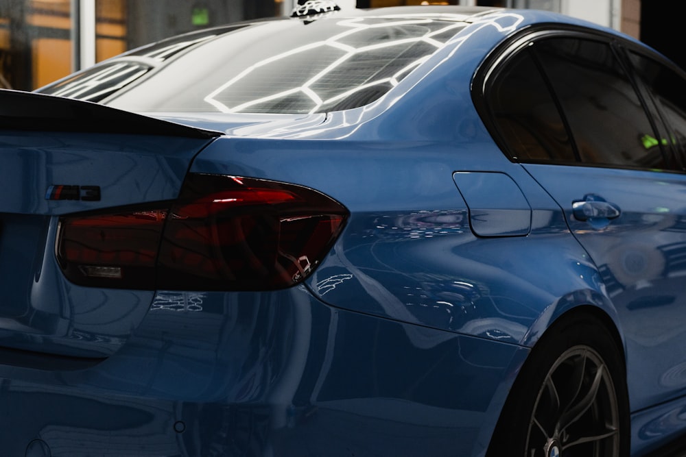 a blue car parked on the side of a street