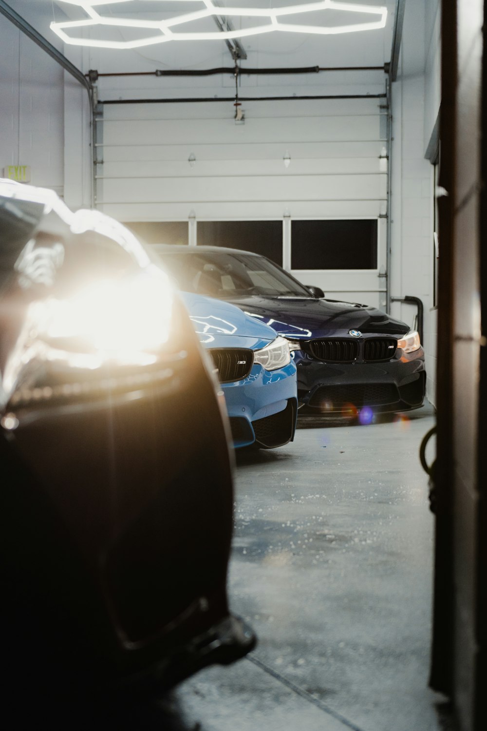 a couple of cars parked in a garage