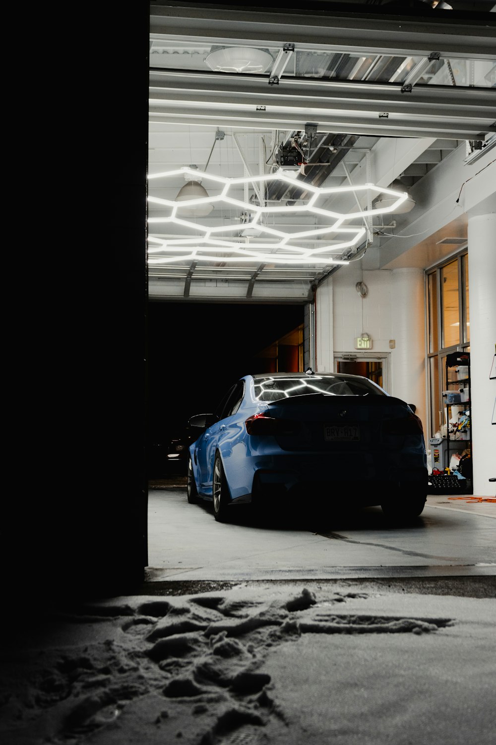 a blue sports car parked in a garage