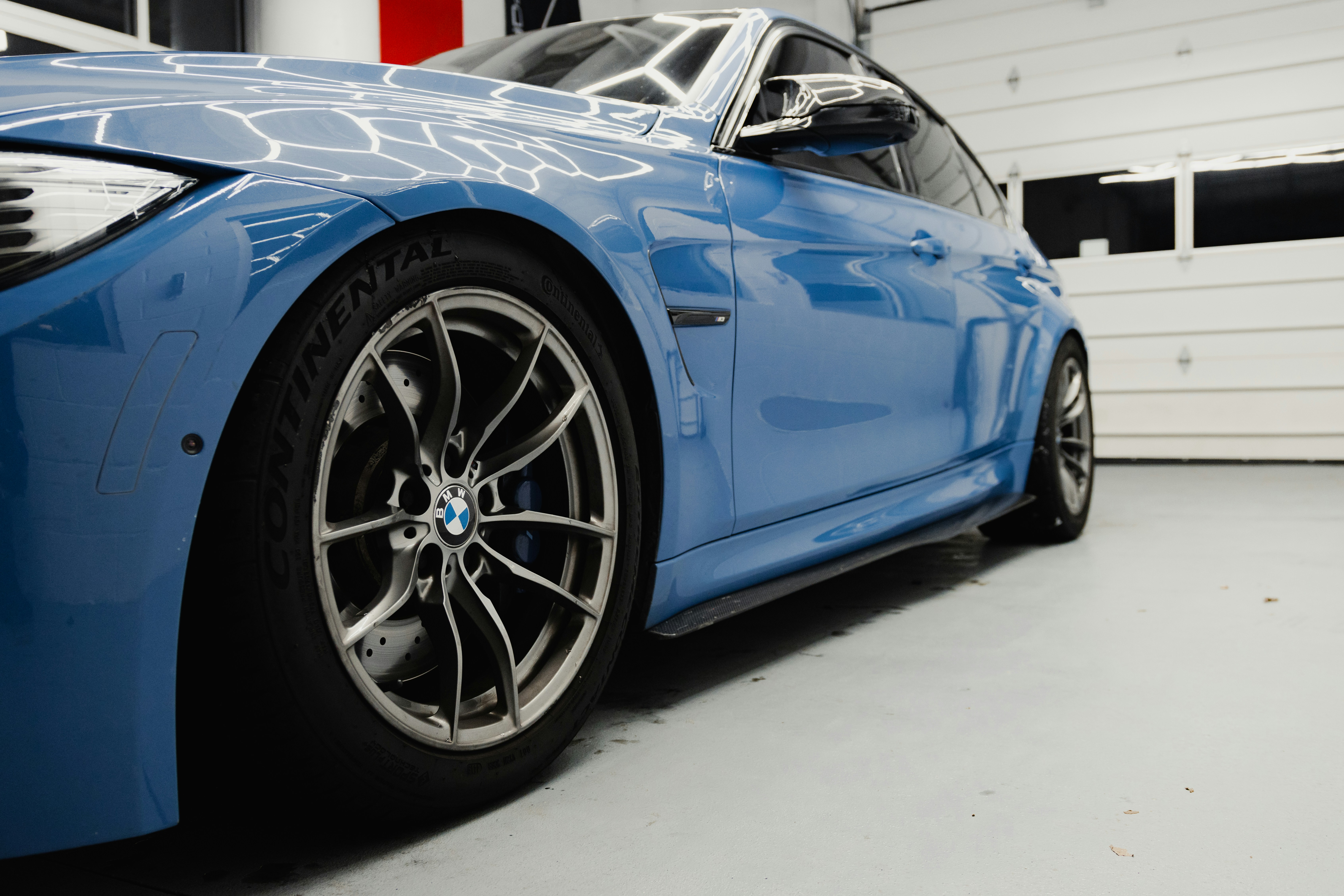 a blue sports car parked in a garage