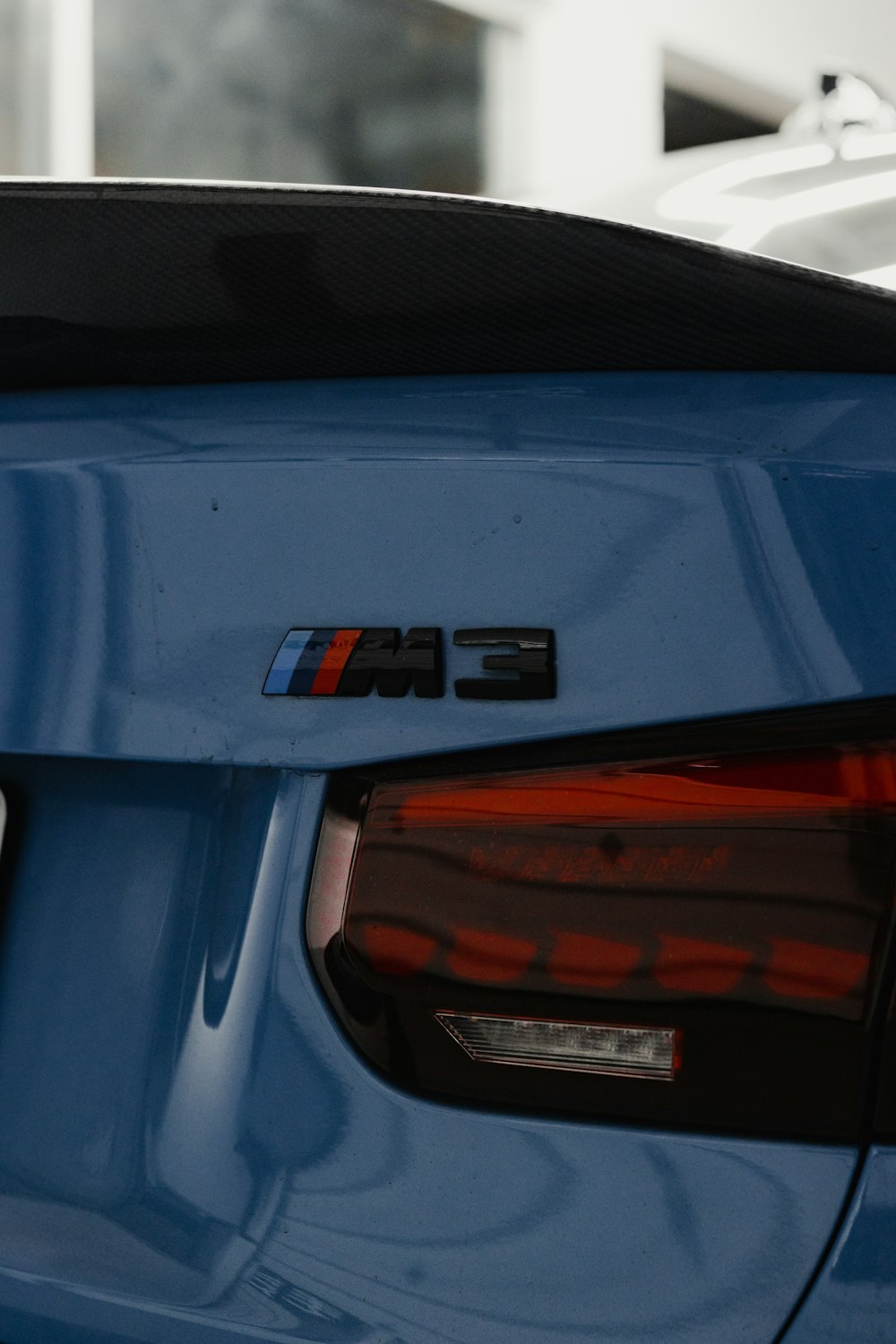a close up of the rear end of a blue car