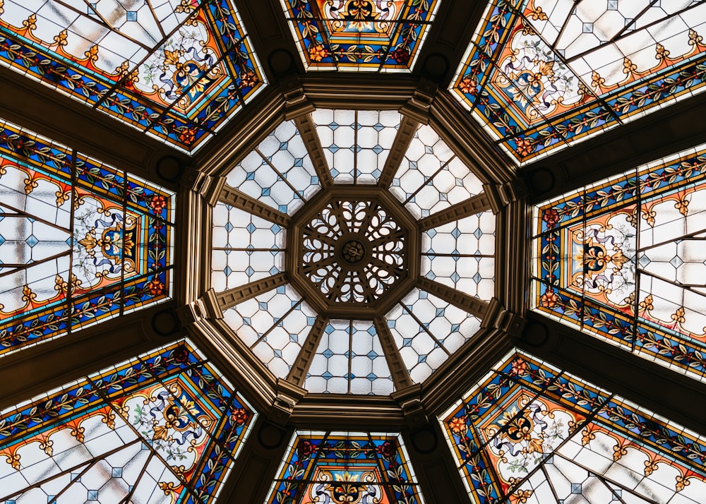 the ceiling of a building has many stained glass windows