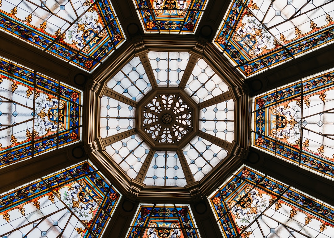 the ceiling of a building has many stained glass windows, Glass roof