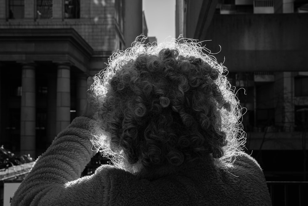 a black and white photo of a woman with curly hair