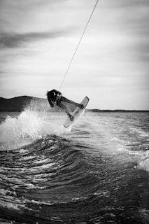 Close-up of a wakeboarder catching air with a focused expression