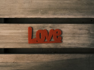 a wooden bench with the word love carved into it
