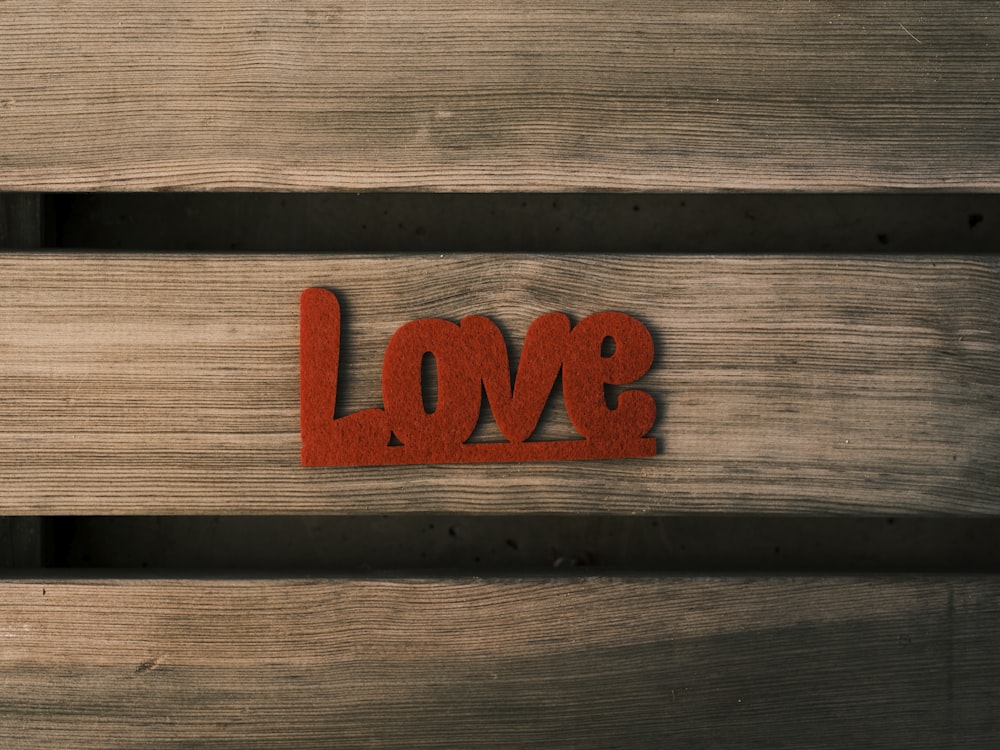 a wooden bench with the word love carved into it