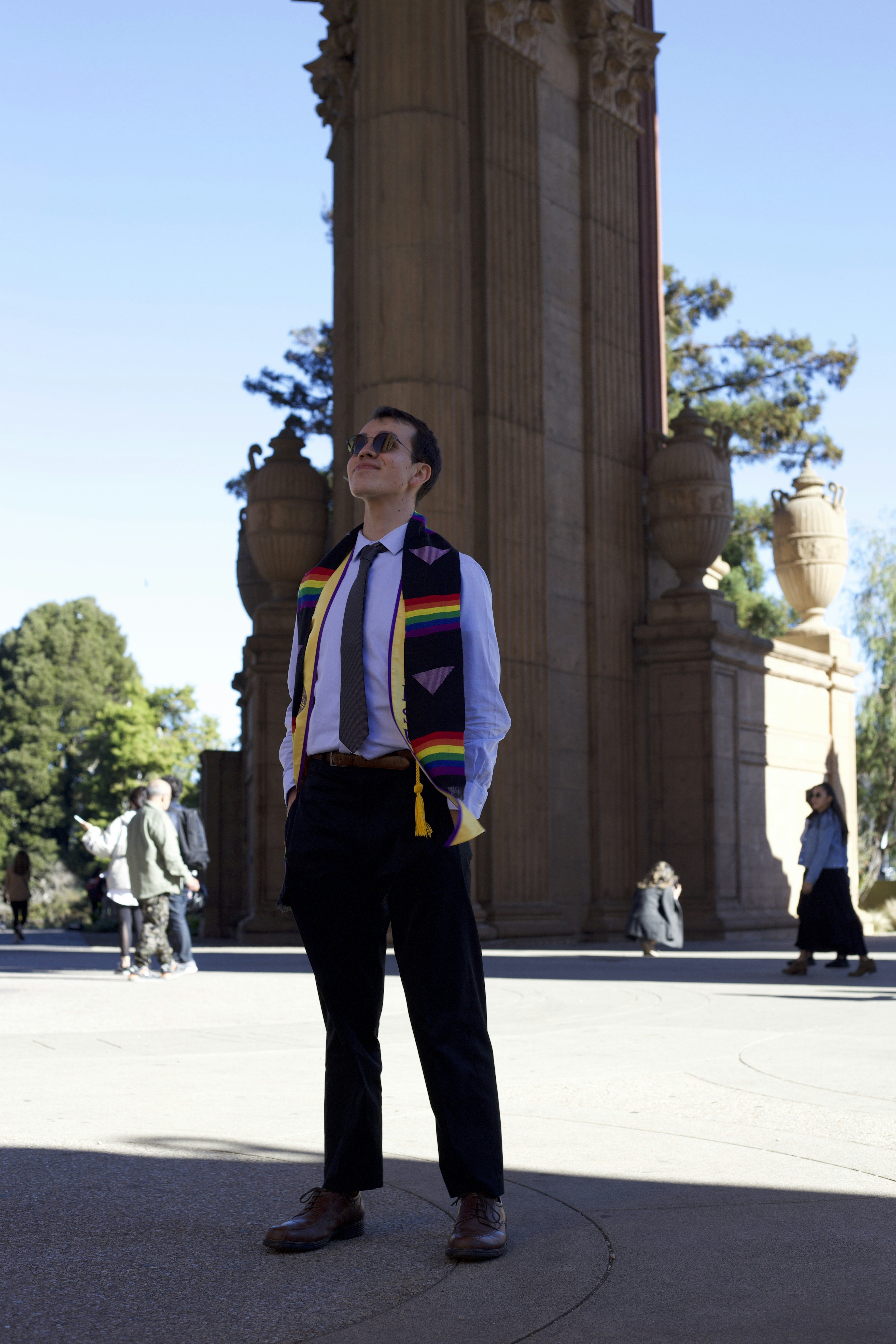 a man standing in front of a tall building