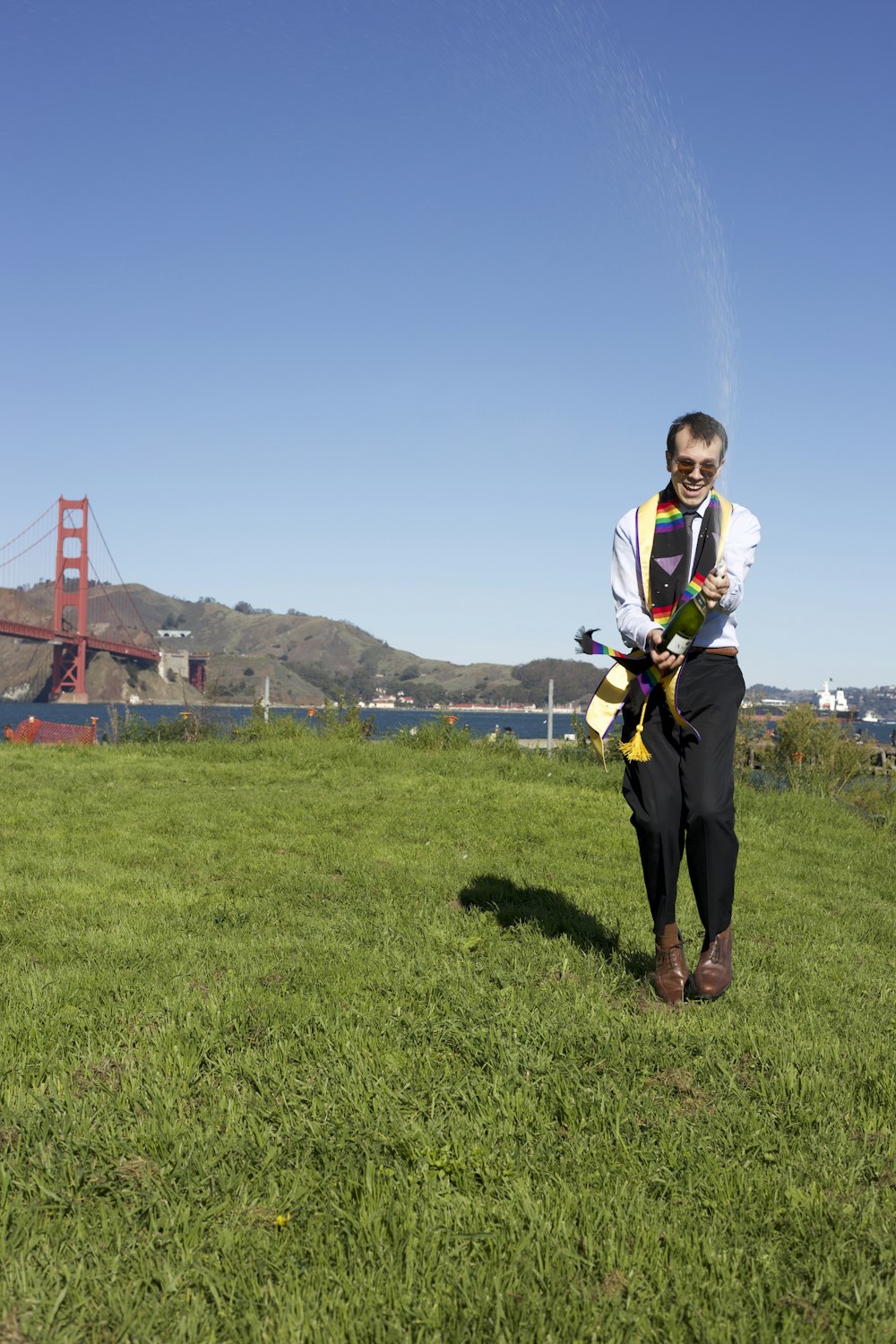 a man standing on top of a lush green field