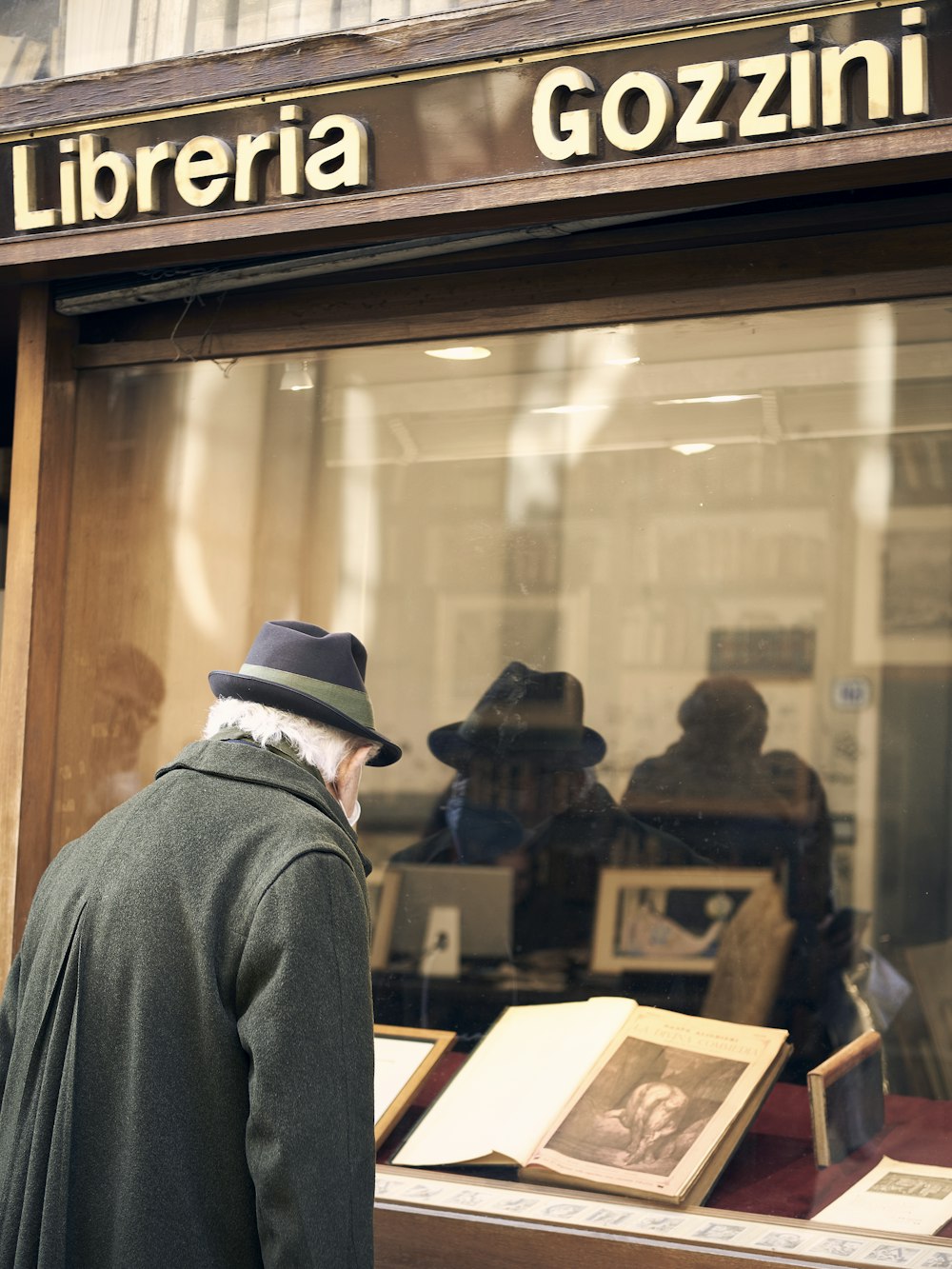 a man standing in front of a store window