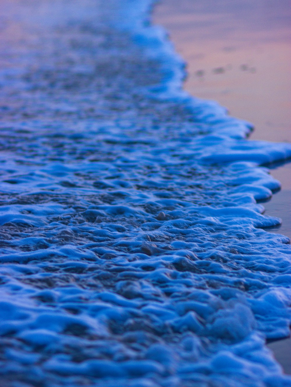 a close up of a wave on a beach