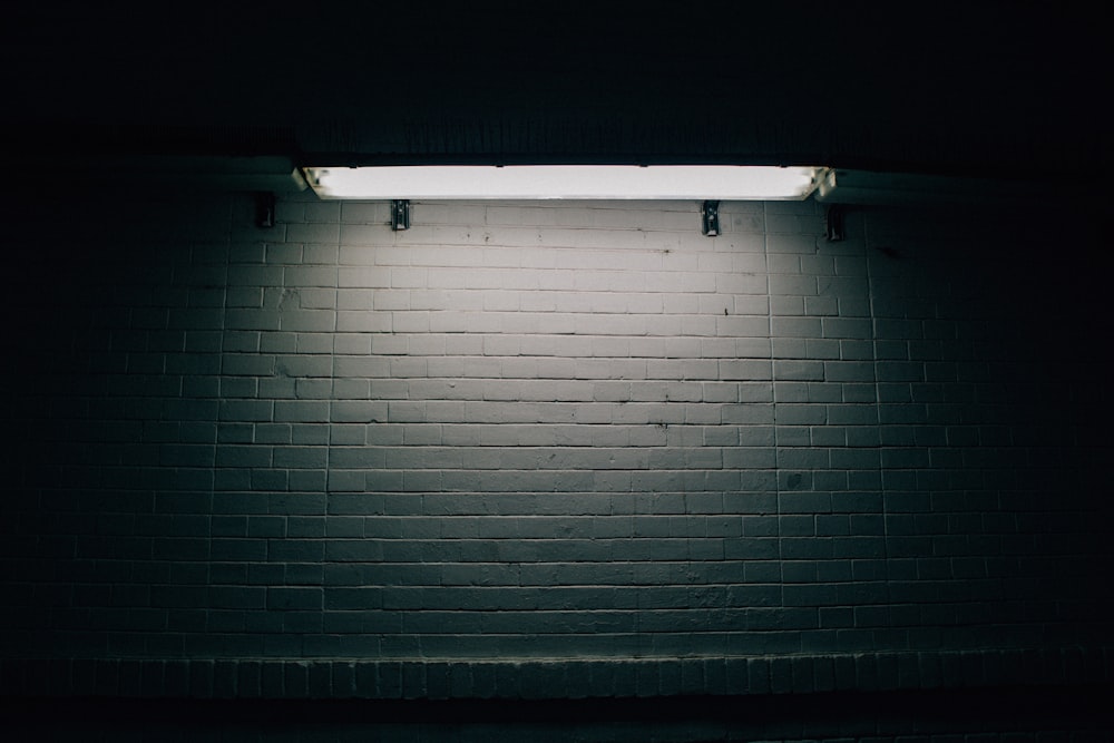 a white brick wall with a light on it