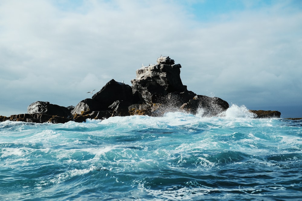 a rock in the middle of a body of water