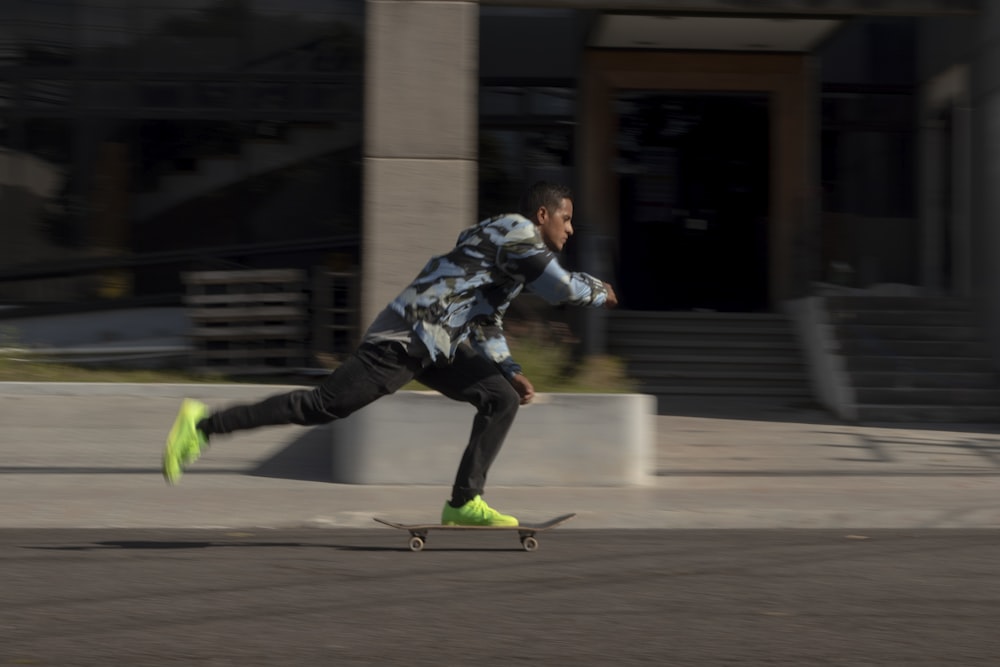 a man riding a skateboard down a street